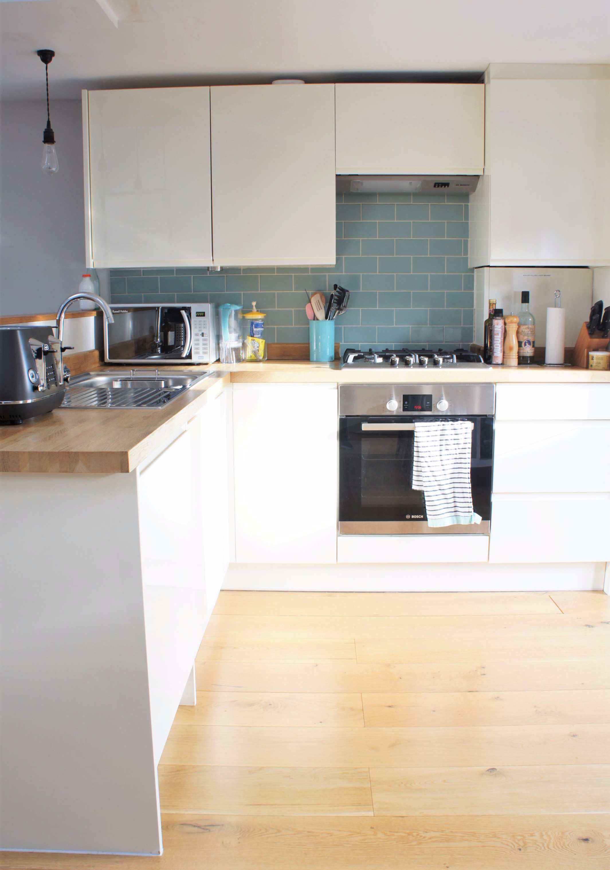 White kitchen and wood counter top