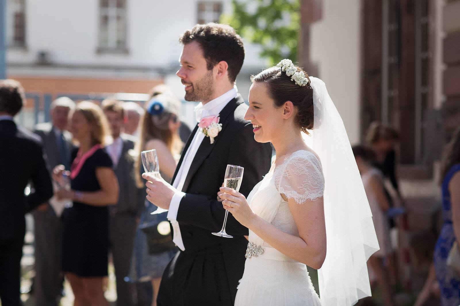Bride and groom drinking champagne
