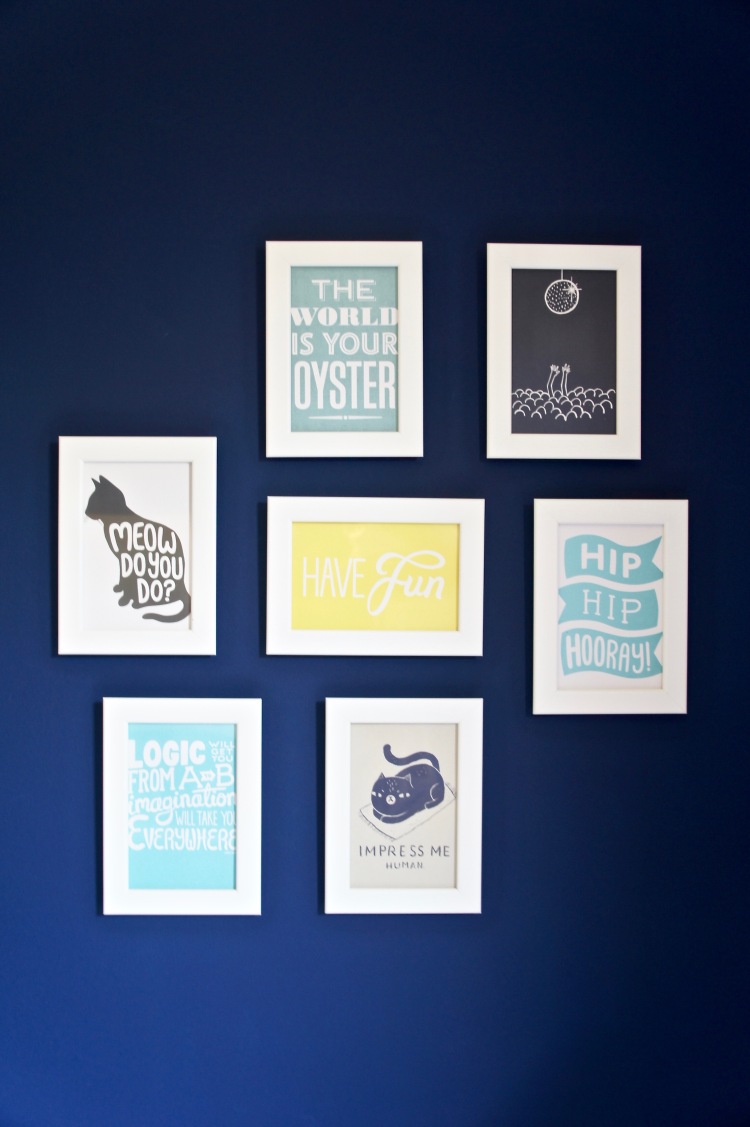 Navy blue wall with postcard gallery wall