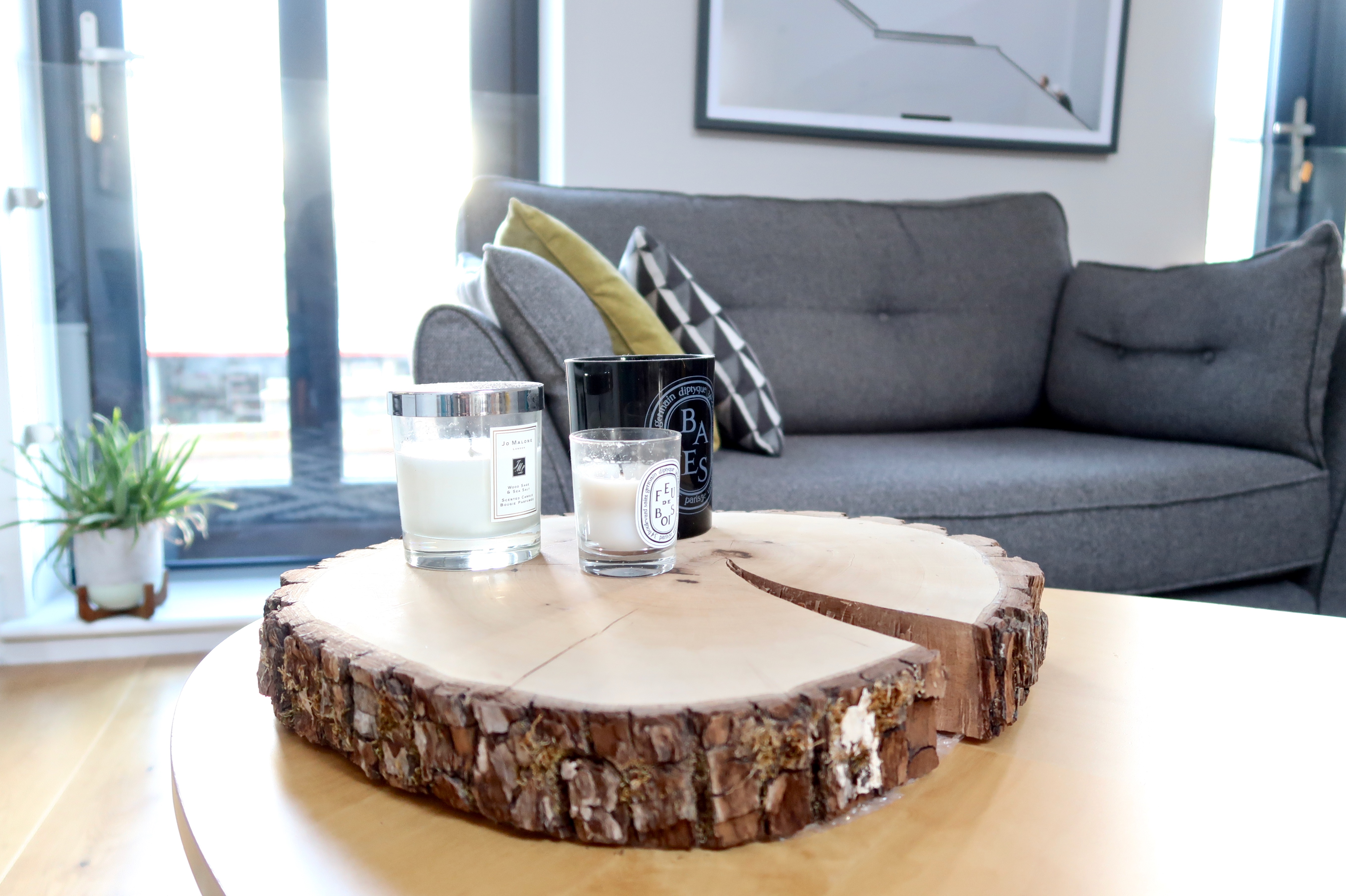 Ikea coffee table, Jo Malone Diptyque candles, wood slice